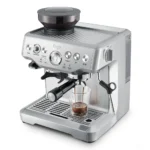 מכונת אספרסו Sage Barista Express (Breville) SES875 נירוסטה במבט עליון אלכסוני שמראה את משטח חימום הספלים ואת מיכל הפולים