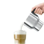 מזיגת חלב מוקצף מכד מקציף החלב Sage Milk Café SMF600 לתוך כוס לאטה